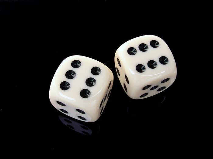 The image of two photoreal dice on a black background