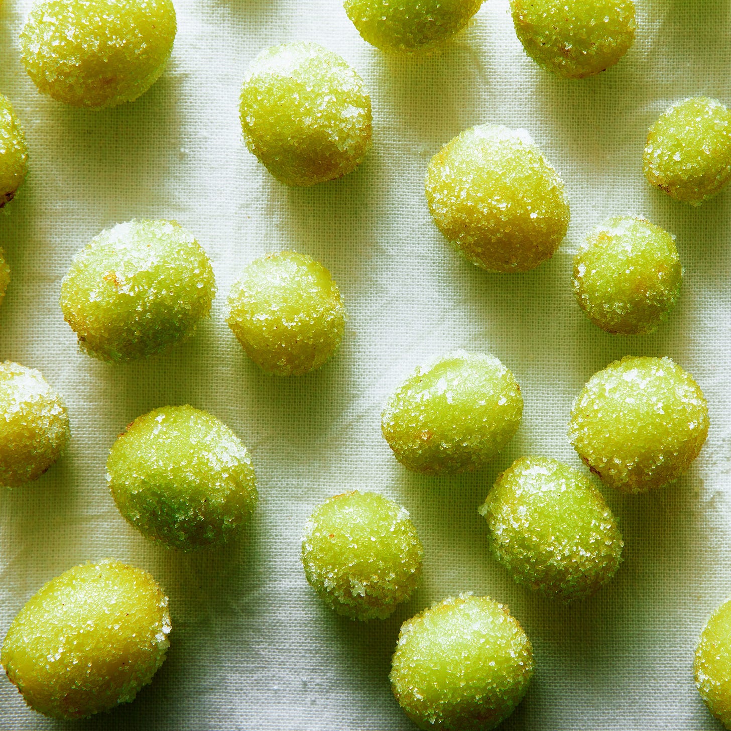 Frozen green grapes rolled in powdered citric acid.