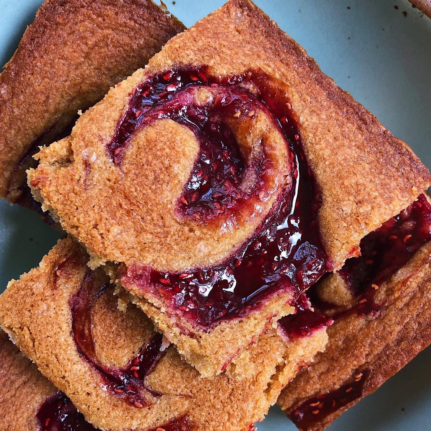 big square of a blondie with strawberry jam swirled throughout