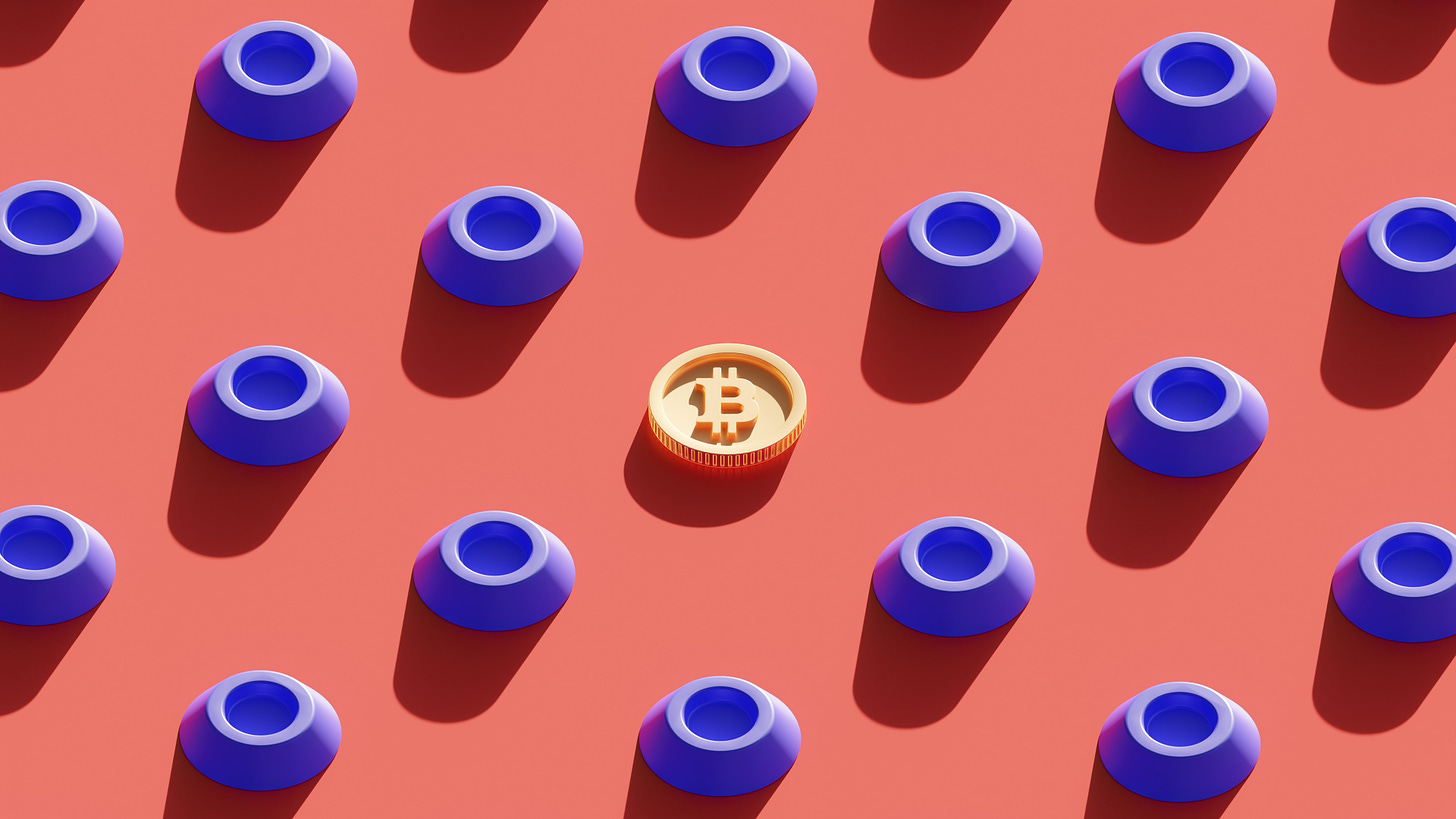 A group of blue plastic containers surrounding a Bitcoin, all sitting on a clay coloured ground