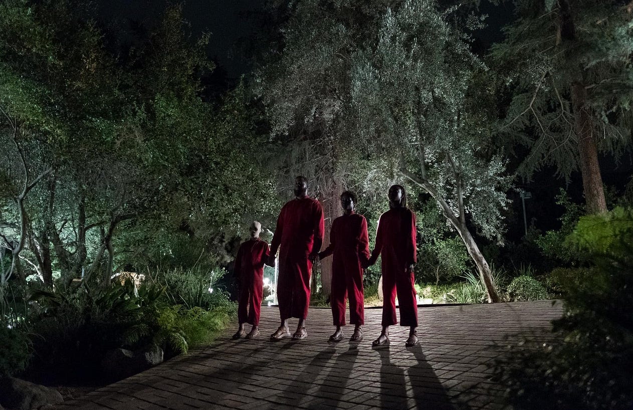 The doppelganger characters standing mencingly in the movie Us / Universal Pictures