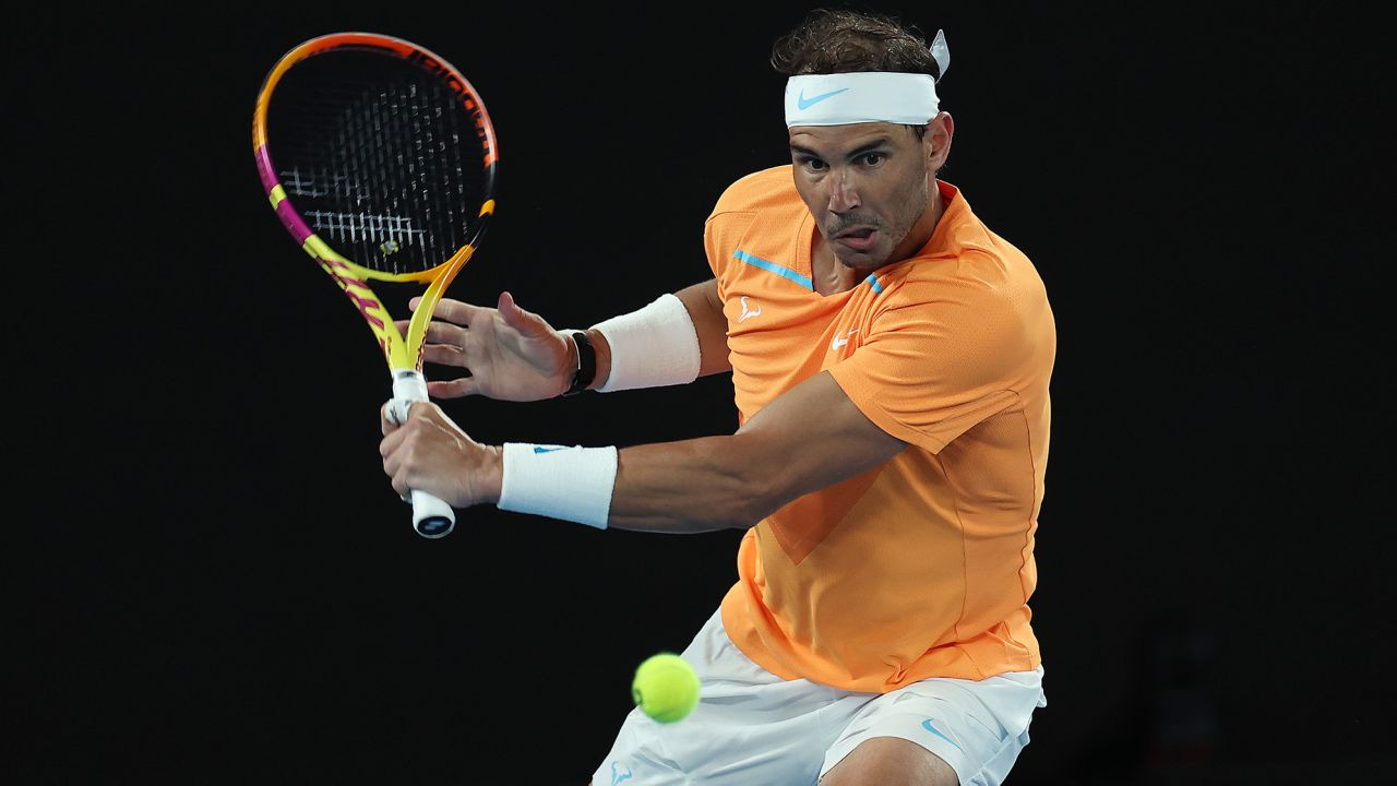 MELBOURNE, AUSTRALIA - JANUARY 18: Rafael Nadal of Spain plays a backhand in their round two singles match against Mackenzie McDonald of the United States during day three of the 2023 Australian Open at Melbourne Park on January 18, 2023 in Melbourne, Australia. (Photo by Cameron Spencer/Getty Images)