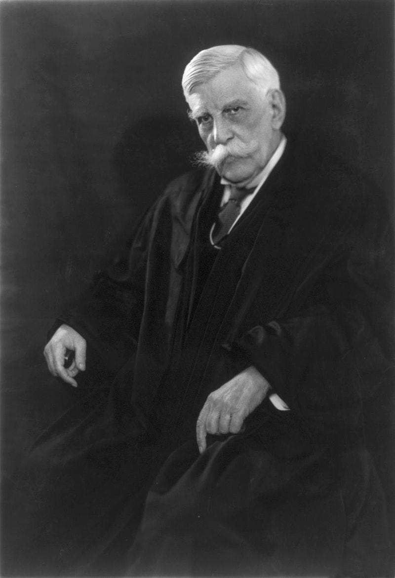 Photograph of Justice Oliver Wendell Holmes, aged about 89, in the robes of a judge