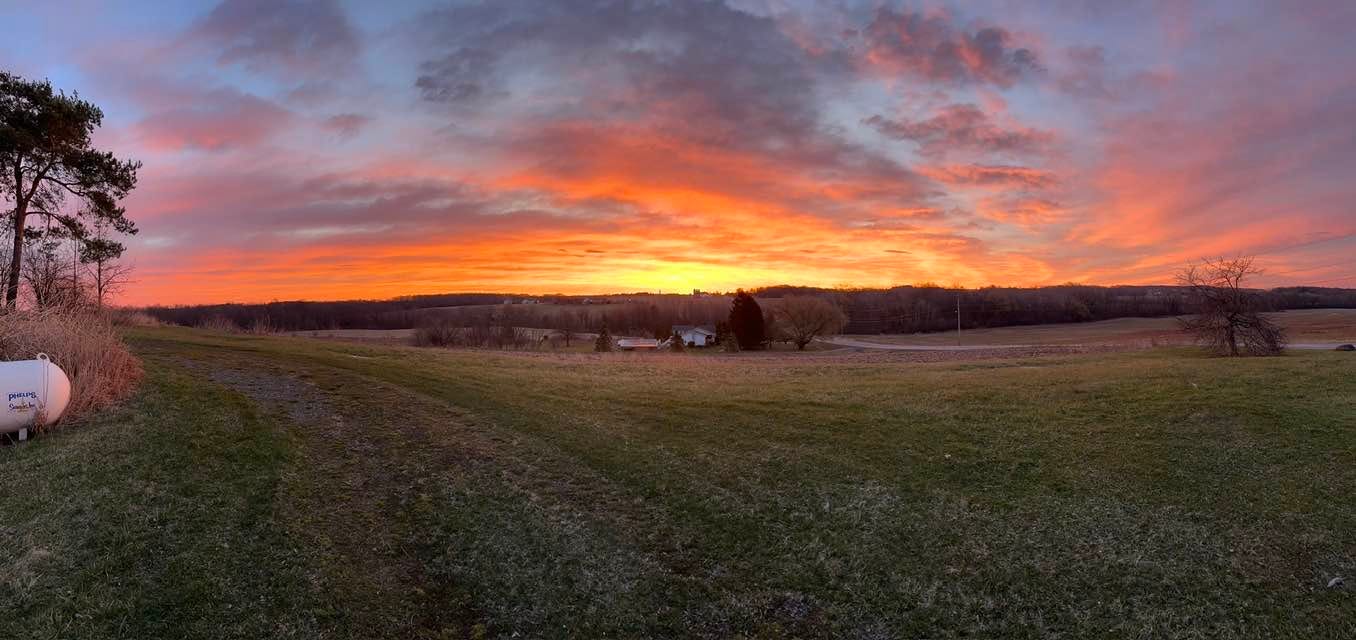 May be an image of silo, twilight, horizon and grass