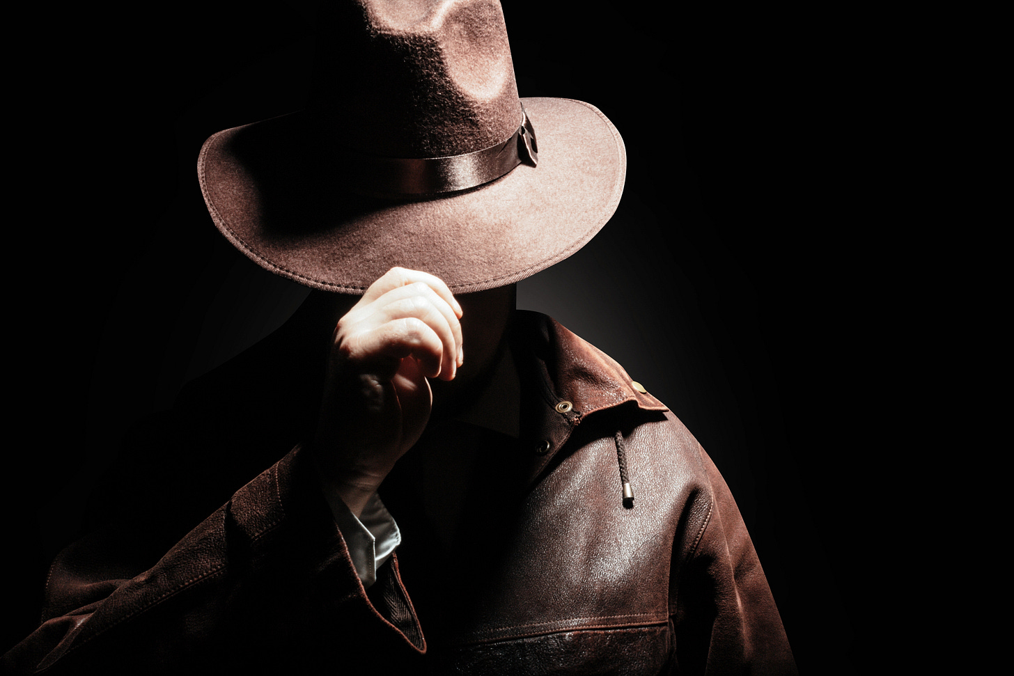 Detective with hat concealing his face