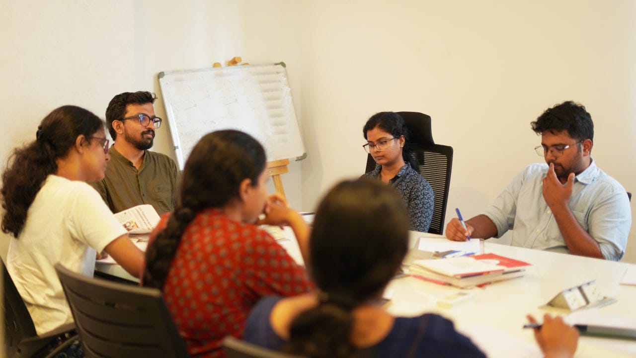 Unnikrishnadas, Lead IAS Faculty and Group Discussion Moderator, with 2024 interview candidates . In the image: Manjusha B George and Kiran Murali who have secured Rank 195 and Rank 468 in 2024.