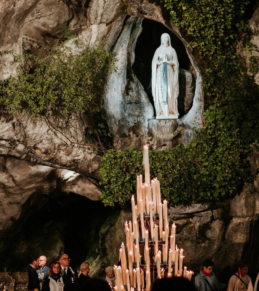 white angel statue on brown rock