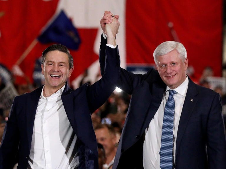 Conservative Party leader Pierre Poilievre is introduced by former Prime Minister Stephen Harper during a campaign rally in Nisku (just south of Edmonton) Monday April 7, 2025. 
