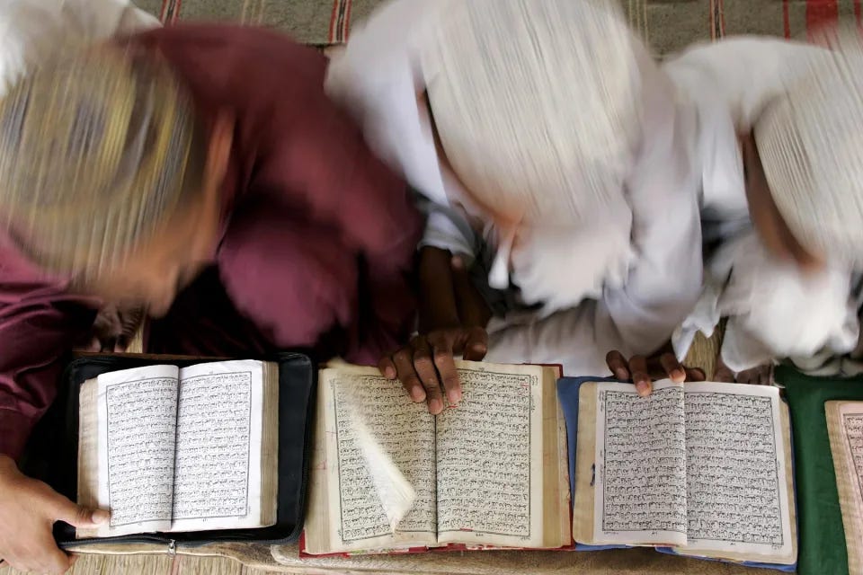 MULTAN, PAKISTAN - JULY 3: Pakistani boys read the Arabic Koran in religion school (Madrassa) on July 3, 2005 in Multan, Pakistan. Many Pakistani families cannot afford to send their children to public schools. Madrassas are free of charge and guarantee the families that their children will turn out to be "good muslims." More importantly, a meal and possible boarding in dormitories is available. Madrassas are supposed to graduate Islamic scholars and teachers but the curriculum does not always offer math, science or literature subjects. They are taught to read and memorize the Koran in Arabic. The federal government supports the registered madrassas, between 12-15,000, and will supply computers but students rarely know how to use them. Jihad is still taught in some of the conservative and radical madrassas. There are nearly one million children in Pakistan's madrassas. Most graduates of madrassas will face unemployment and are easy recruits for Islamic militant organizations that proliferate in Pakistan. With the failure of the country's public education system, madrassas never suffer from low enrollment. Many of the more well endowed madrassas are supported by the Wahabi sect foundations and mosques in Saudi Arabia. (Photo by Robert Nickelsberg/Getty Images)