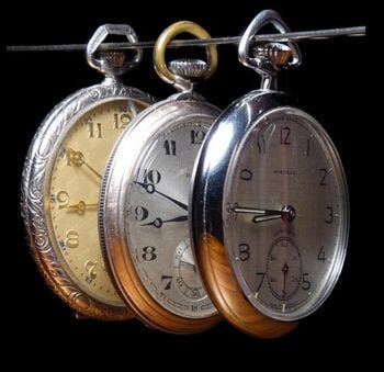 Three pocket watches on a wire
