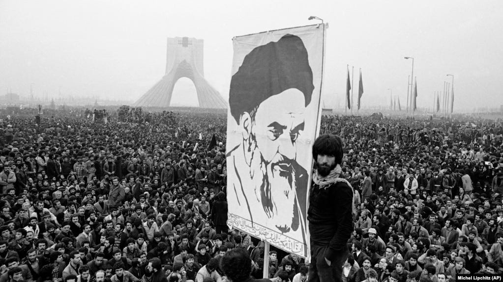In this Dec. 10, 1978 file photo, demonstrators hold up a poster of exiled Muslim leader Ayatollah Ruhollah Khomeini during an anti-shah demonstration in Tehran, Iran. Khomeini would soon return to establish a religious authoritarian regime.