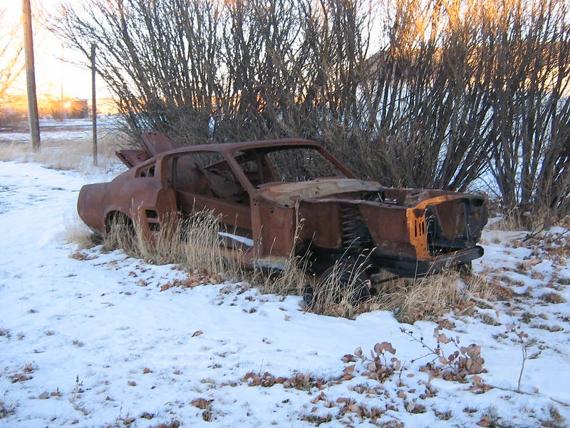 A rusted out Ford Mustang in Warner, Alberta