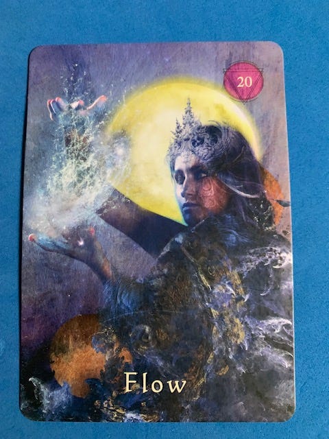 Image of an oracle card with a gorgeous mythical woman and the word "Flow."