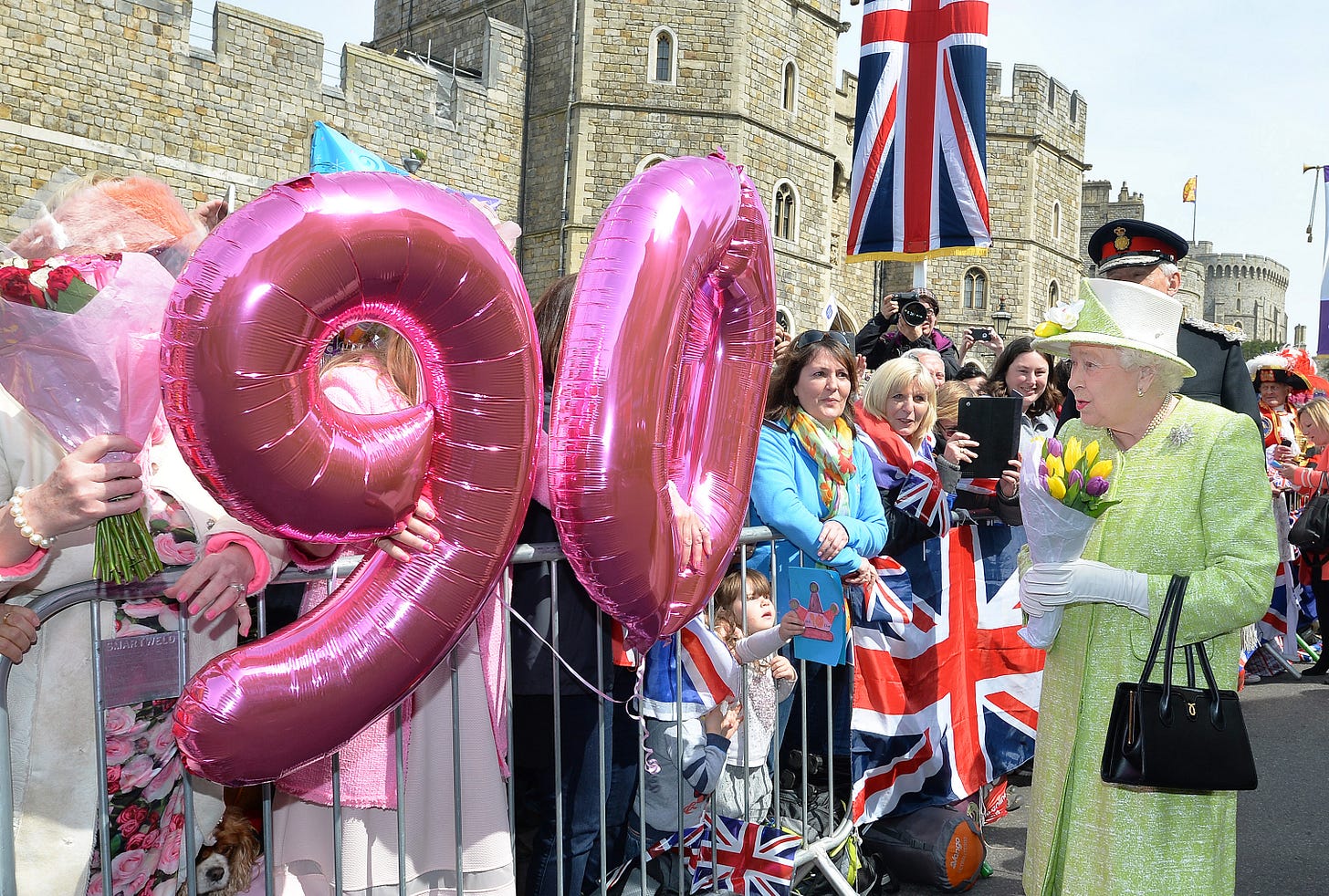 Queen Elizabeth outside Windsor Castle in front of 90 balloons
