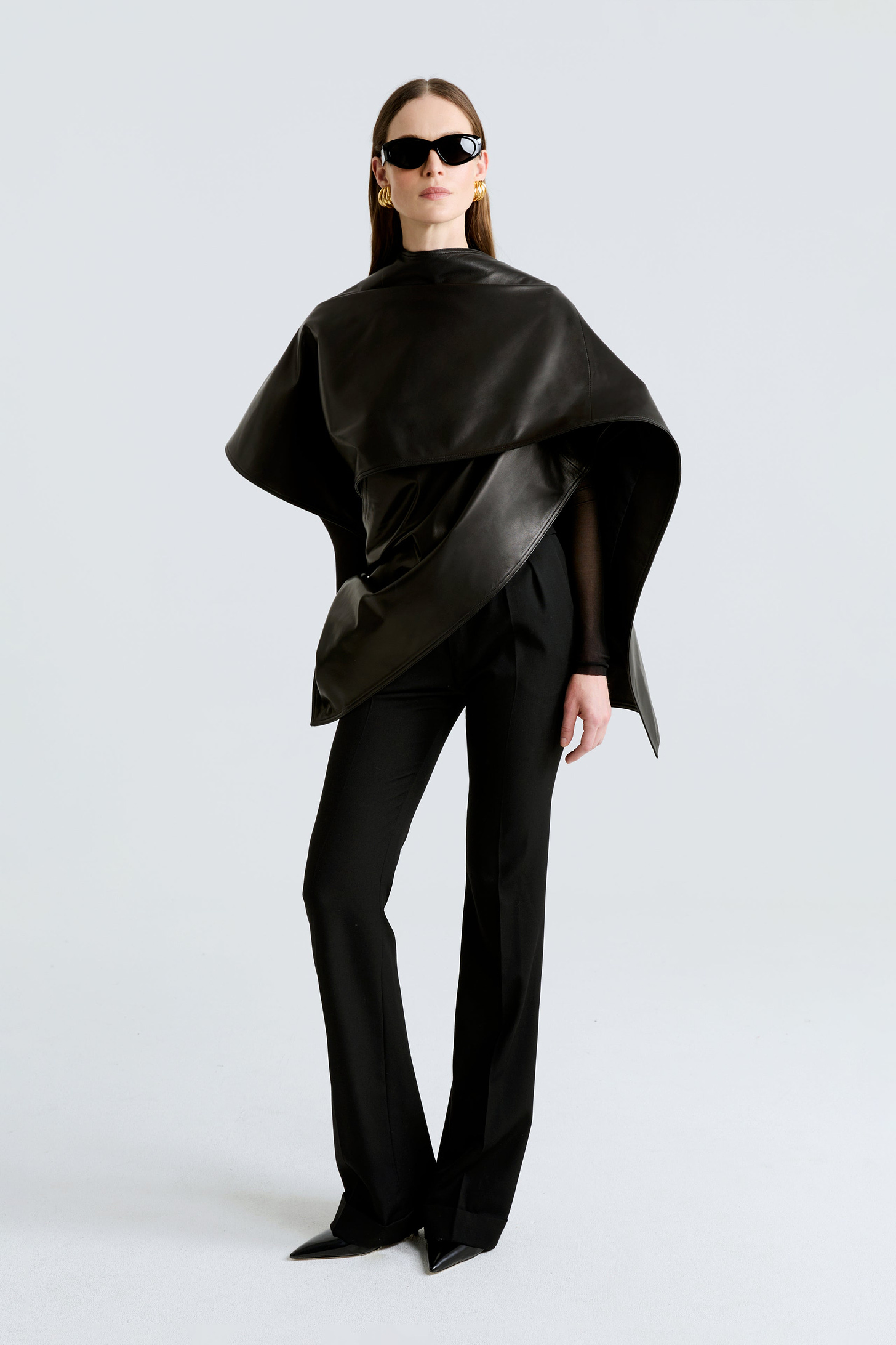 Model is wearing the Edra Black Sleek Leather Cape Front