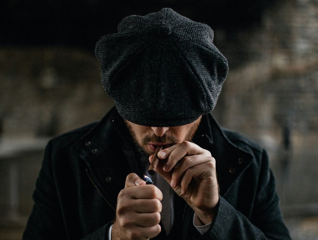 man in black knit cap smoking cigarette