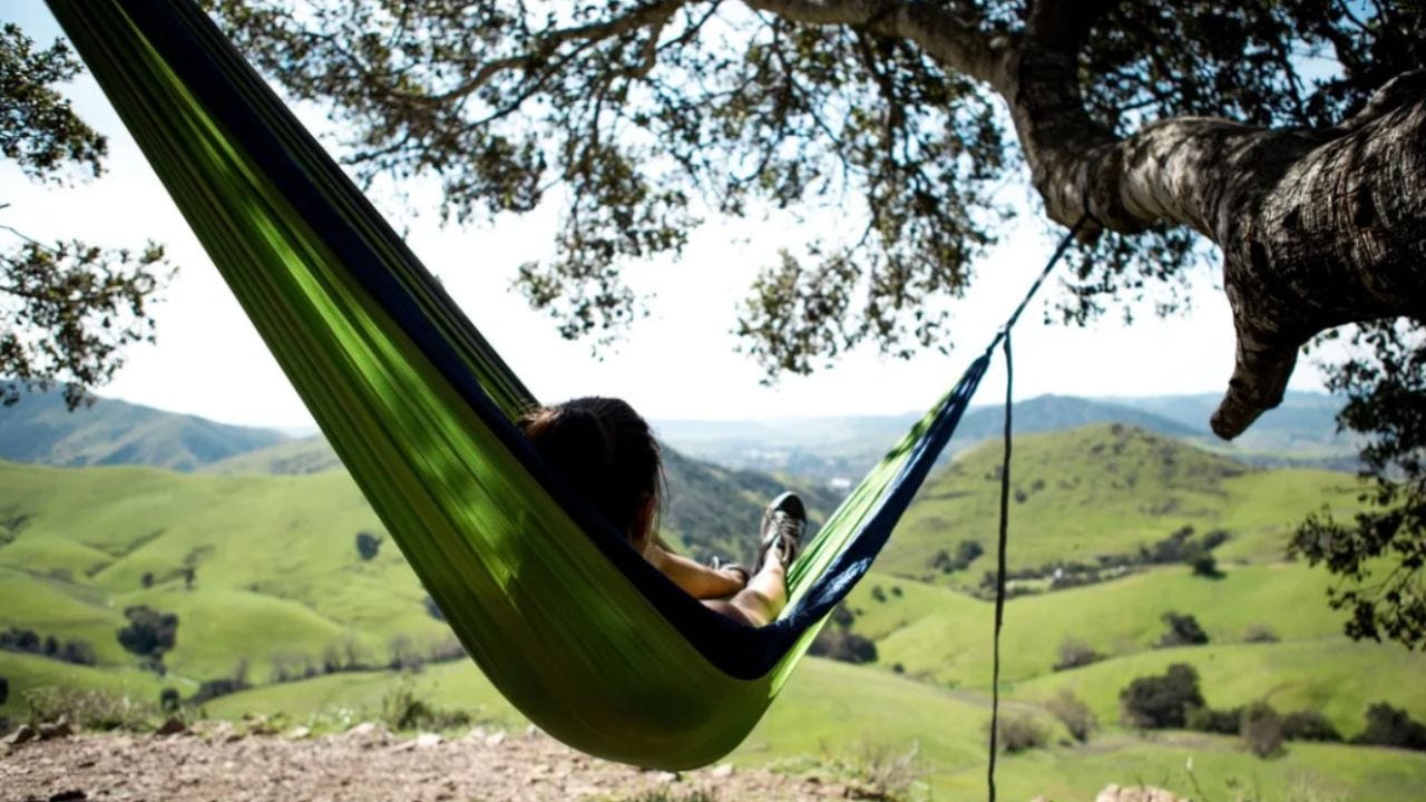 person using hammock from site of CHICO Hängematte