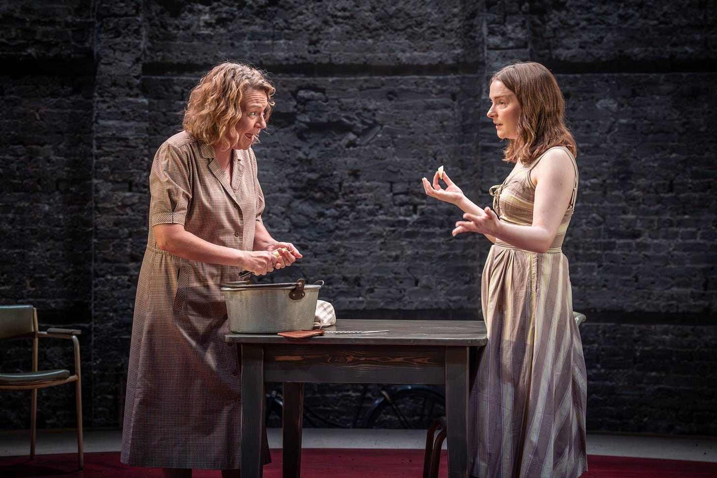 A photo of Roots at The Almeida showing two actors talking while peeling potatoes