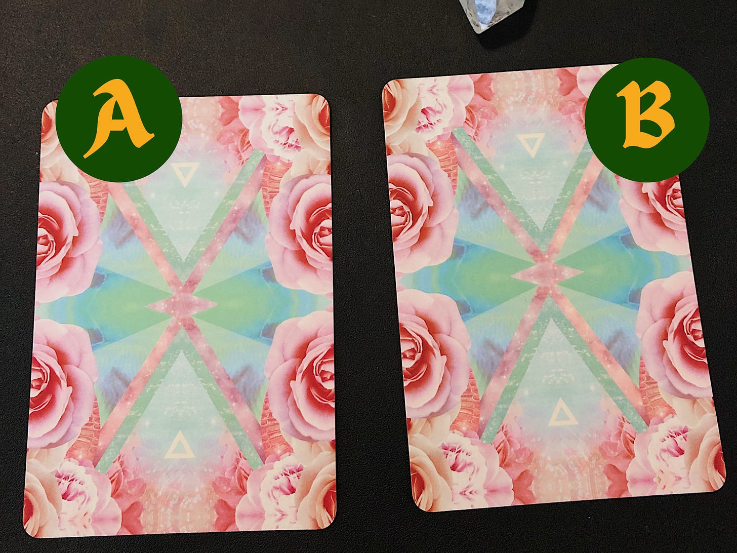 Two down-facing oracle cards with the lefthand one saying "A" and the righthand one saying "B."