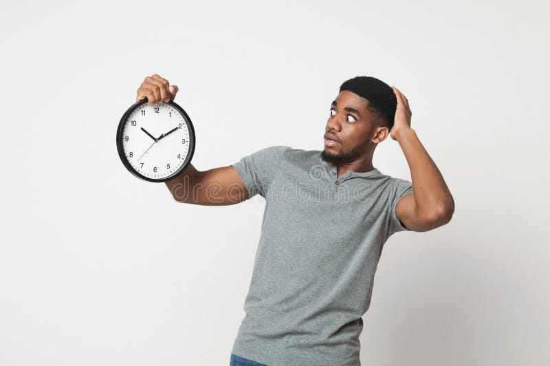 Shocked Black Man Holding Wall Clock Over White Background Stock Image ...