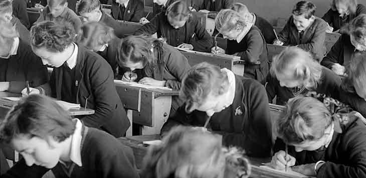 Archive photo of secondary school girls taking an exam.