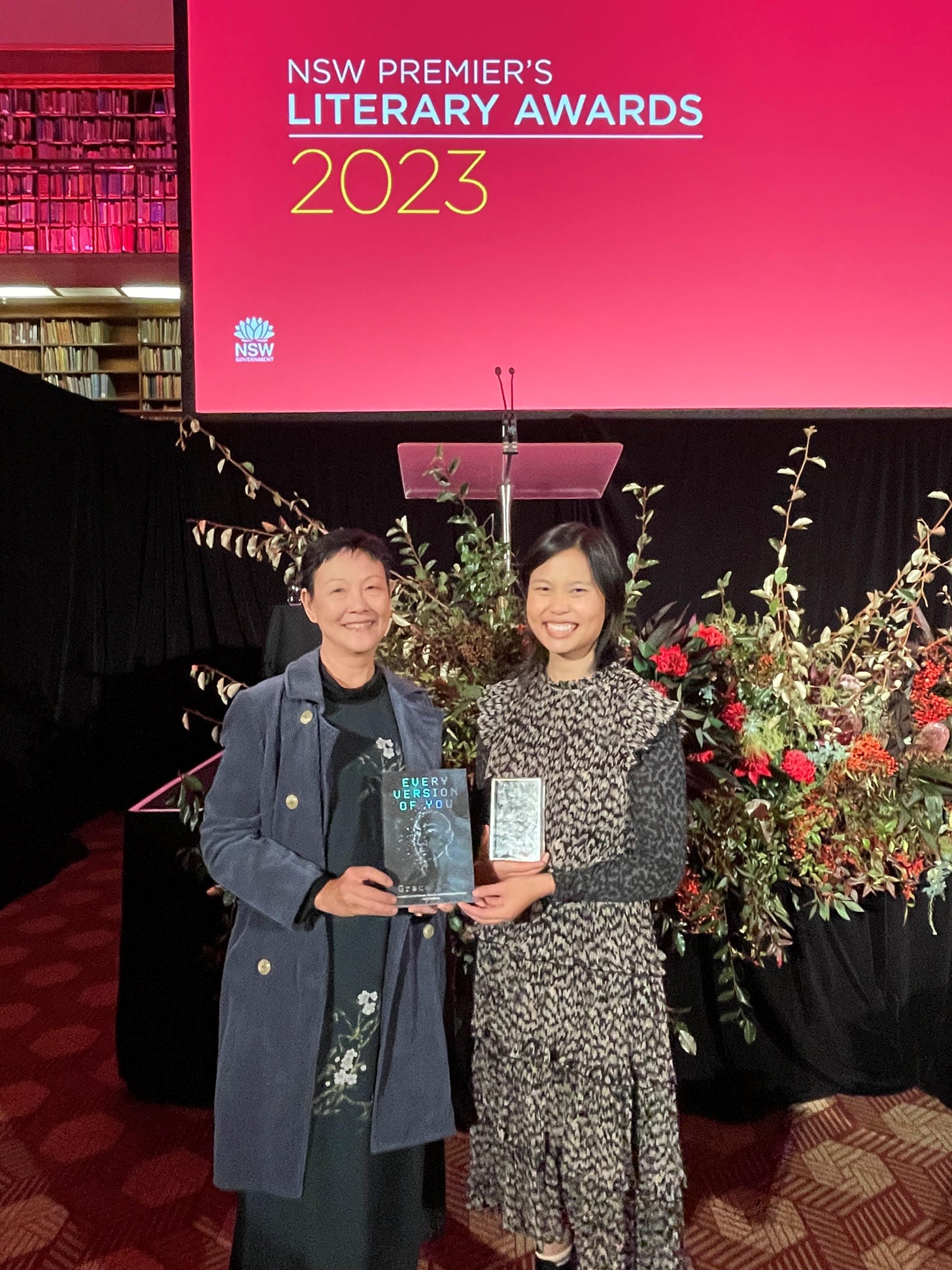 A photo of Grace Chan and Beth Yahp at the NSW Premier's Literary Awards, holding Grace's book and a trophy