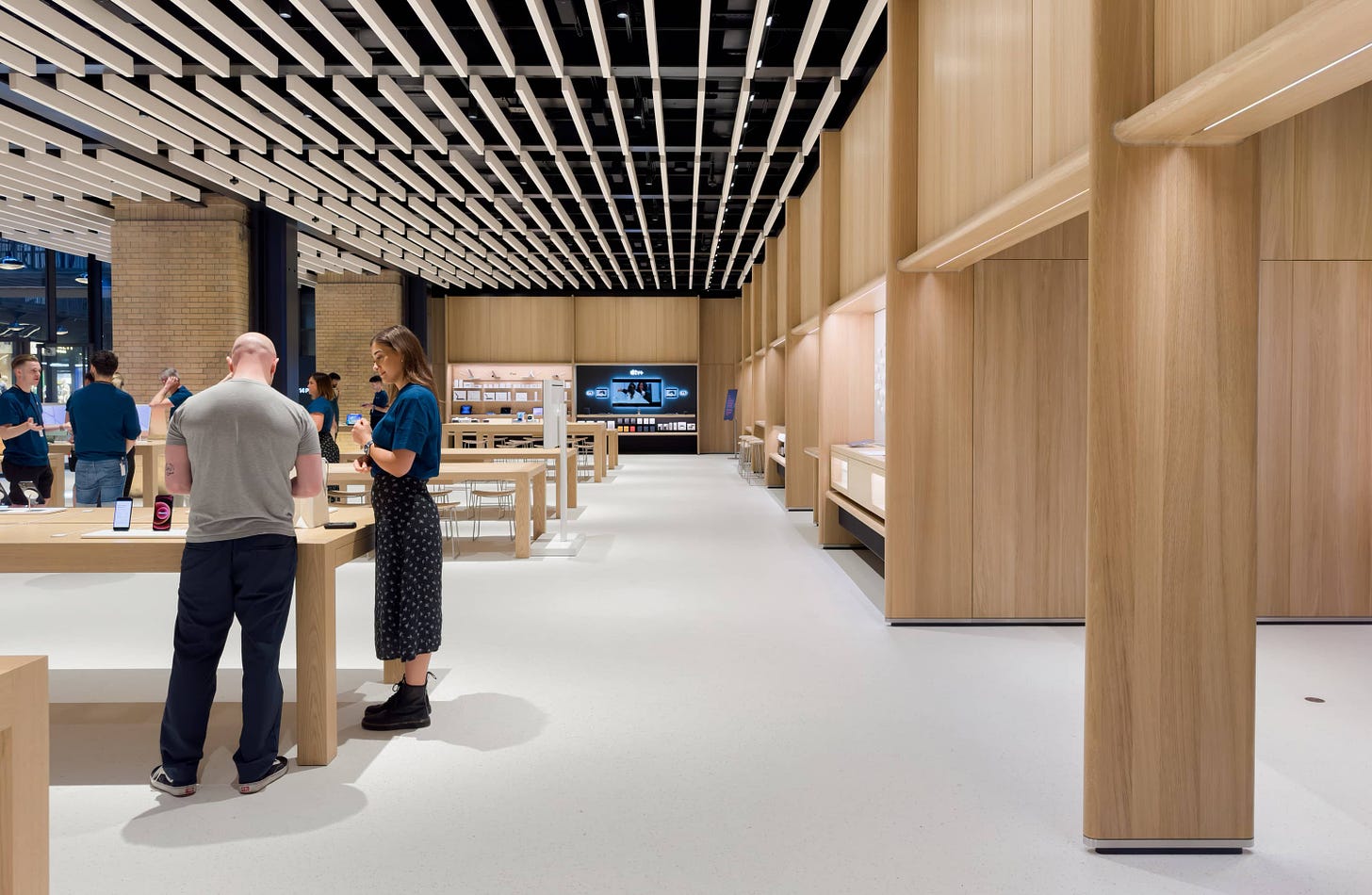 The interior of Apple Battersea. The floor is one seamless stretch of poured terrazzo.