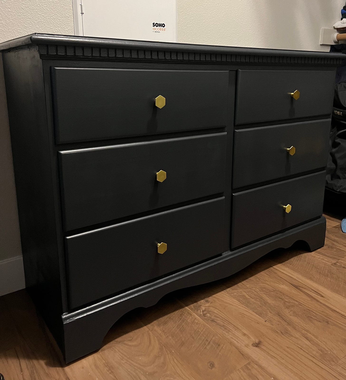 The aforementioned dresser! It's in a closet. Dark grey, 6 drawers, with little brass hexagonal drawer pulls in the center of each one. It looks deceivingly good.