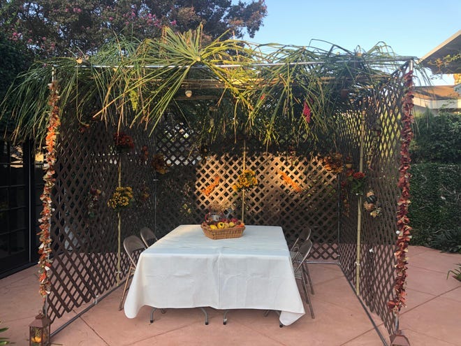 Becky Sobelman-Stern uses palms from an on overgrown tree for the roof of her the sukkah in Sherman Oaks, California.