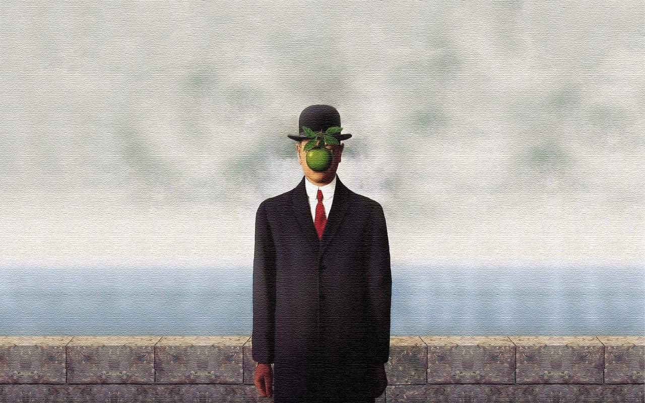 Son of Man by Magritte. A man in a dark suit and bowler hat faces us with a green apple and leaves suspended in front of his face, defying gravity and obscuring his vision.