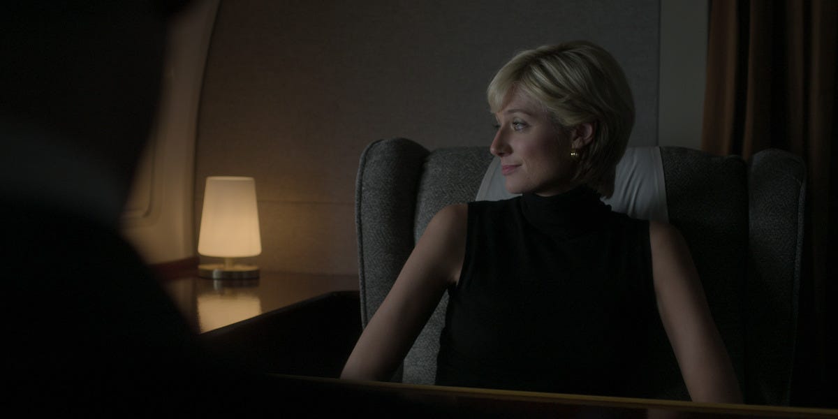 Elizabeth Debicki as Princess Diana looks out the window on a plane in Season 6 of ‘The Crown’