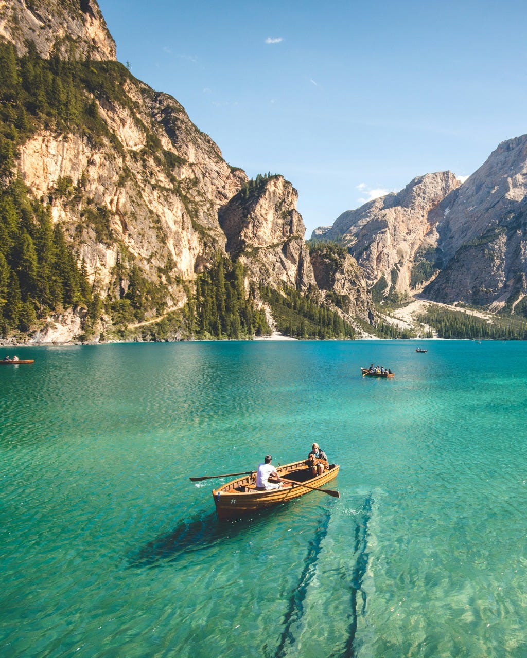 May be an image of 2 people, boat and lake