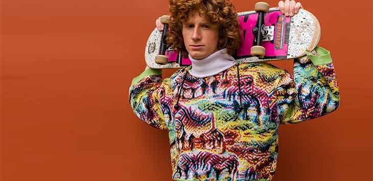 Photo of a fashion model wearing one of Cap_able's multi-coloured jumpers.