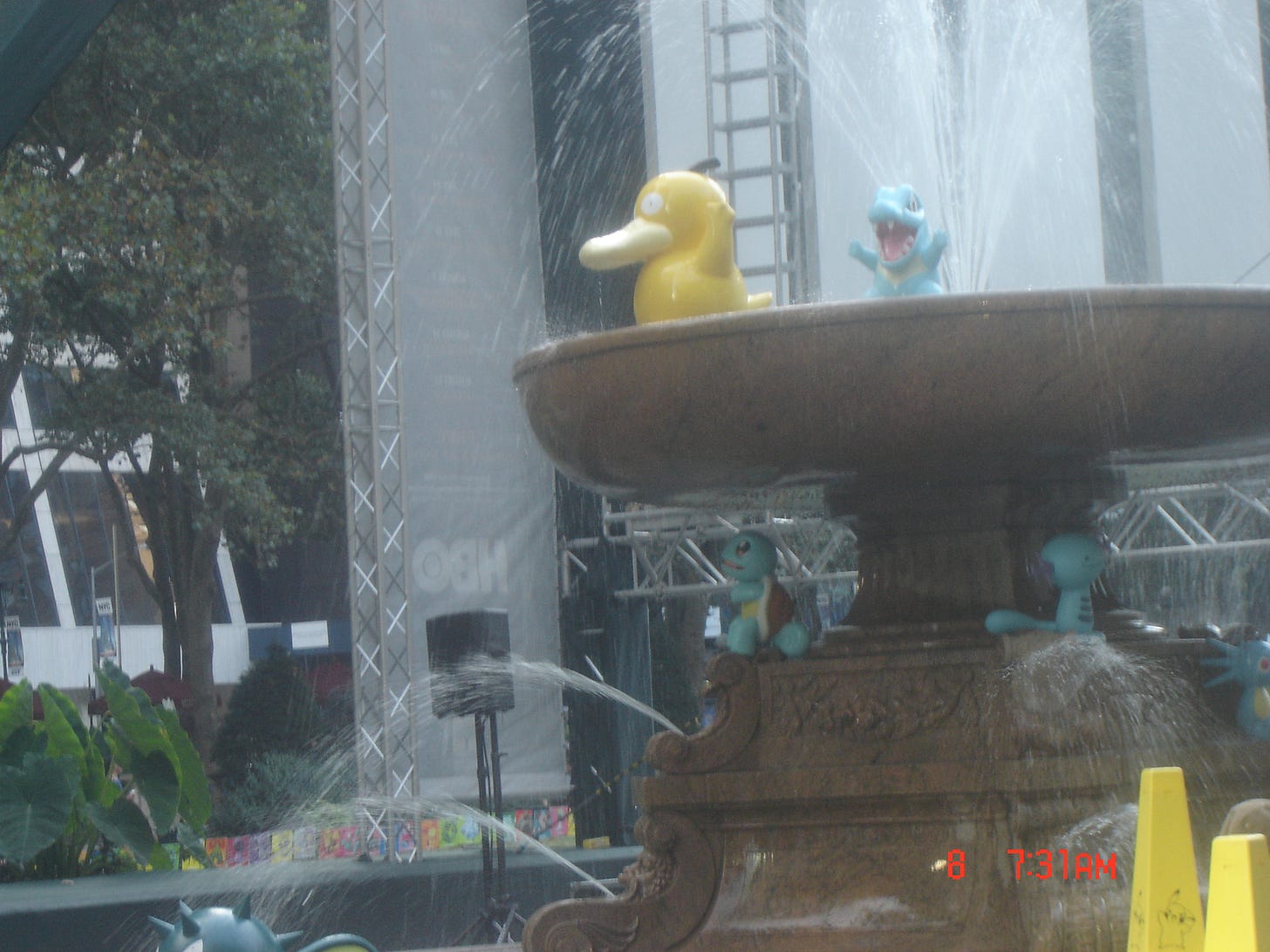 Statues from the original Pokémon Center New York store made an appearance across Bryant Park that day. In this photo, we can see Psyduck, Totodile, Squirtle, Wooper, Horsea, and Qwilfish around the fountain Statues from the original Pokémon Center New York store made an appearance across Bryant Park that day. In this photo, we can see Psyduck, Totodile, Squirtle, Wooper, Horsea, and Qwilfish around the fountain