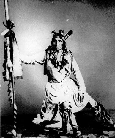 Sioux chief Little Crow sitting in battle regalia for a portrait