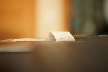 Image of a receipt laying on a table.