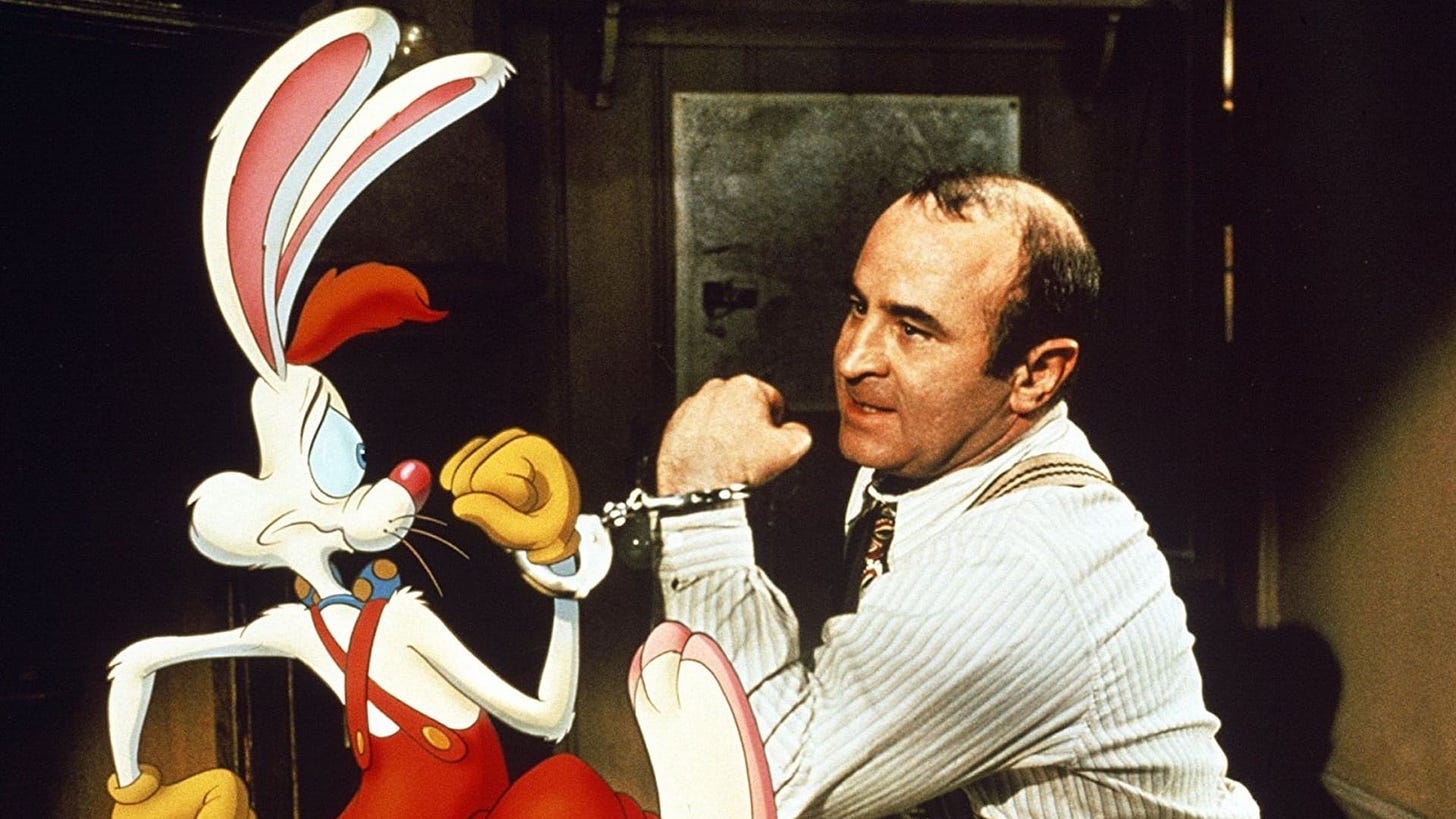 Who Framed Roger Rabbit | Still features Bob Hoskins handcuffed to Roger Rabbit, an animated cartoon rabbit.