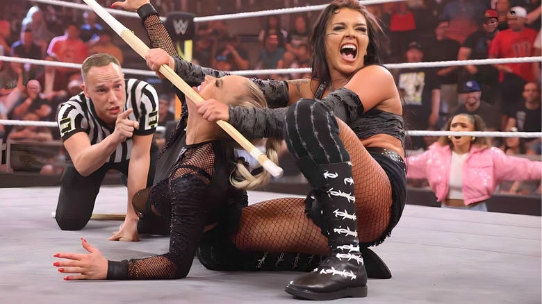 Cora Jade chokes Dana Brooke with a kendo stick