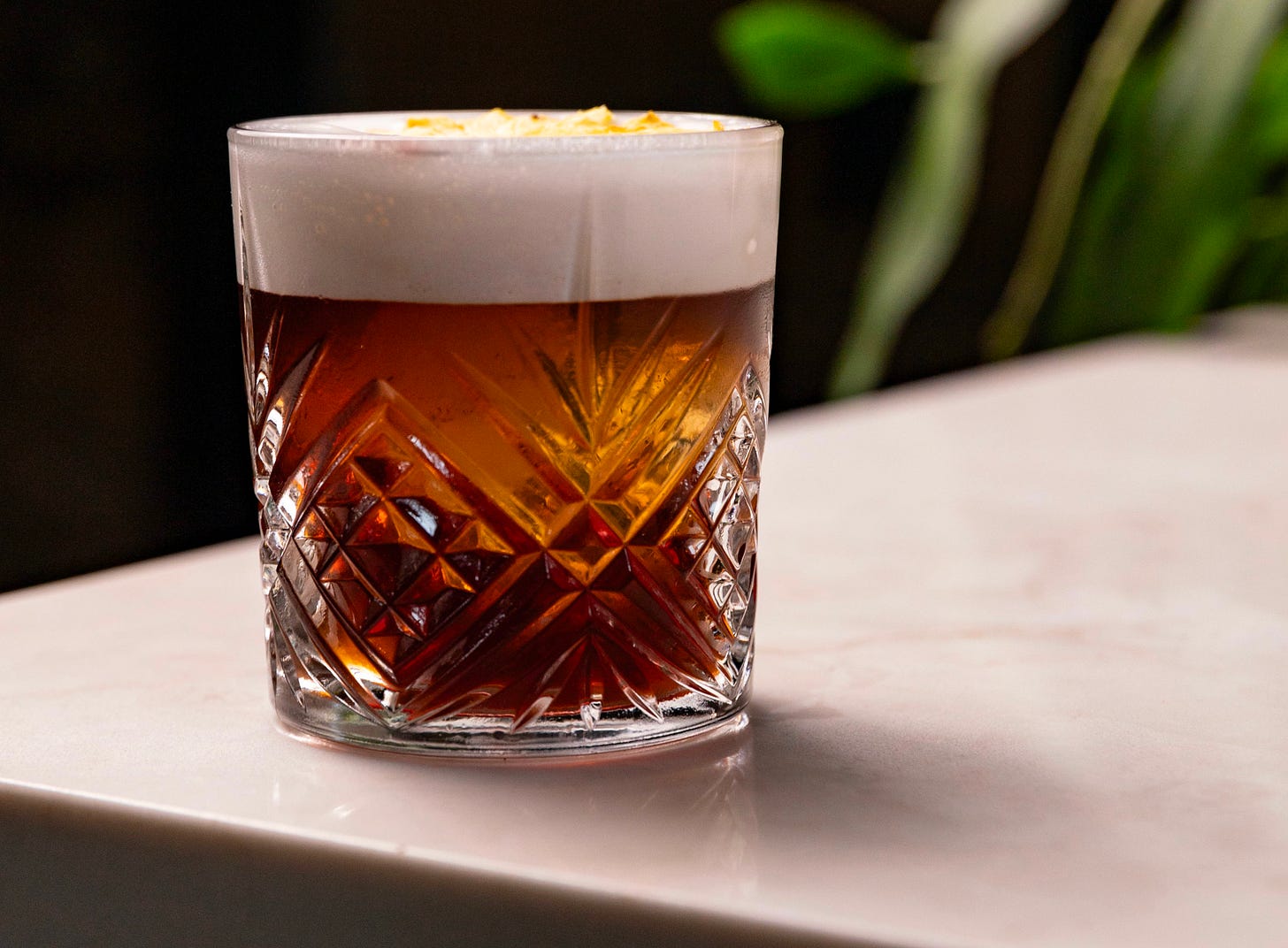 brown cocktail in rocks glass