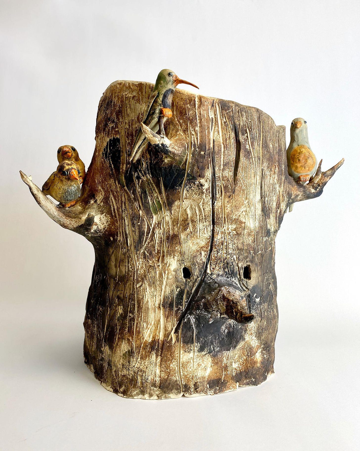 Ceramic tree stump mask with birds on branches