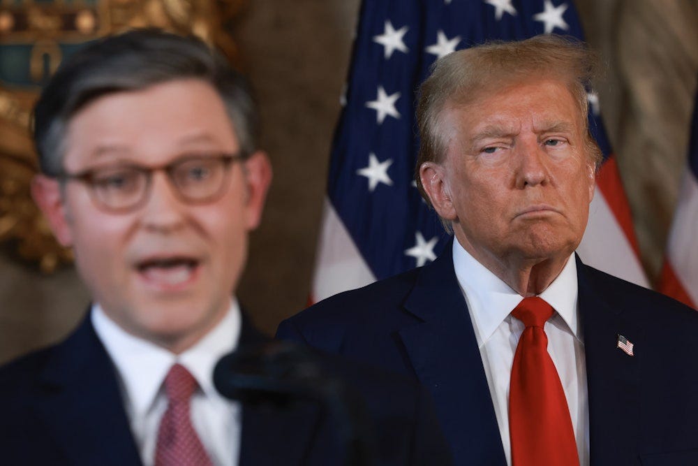 Trump listens as House Speaker Mike Johnson speaks during a press conference at Mar-a-Lago