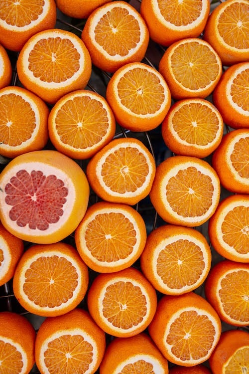 Free Fresh juicy oranges and grapefruit served on table Stock Photo