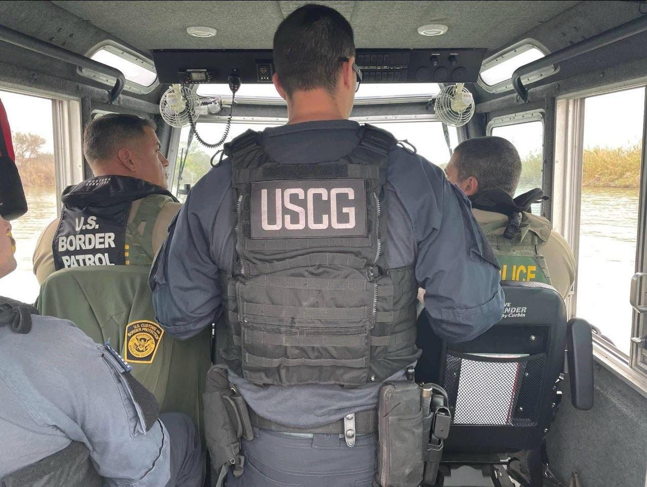 Border Patrol Agents and US Coast Guardsmen aboard a riverine patrol boat on the Rio Grande.