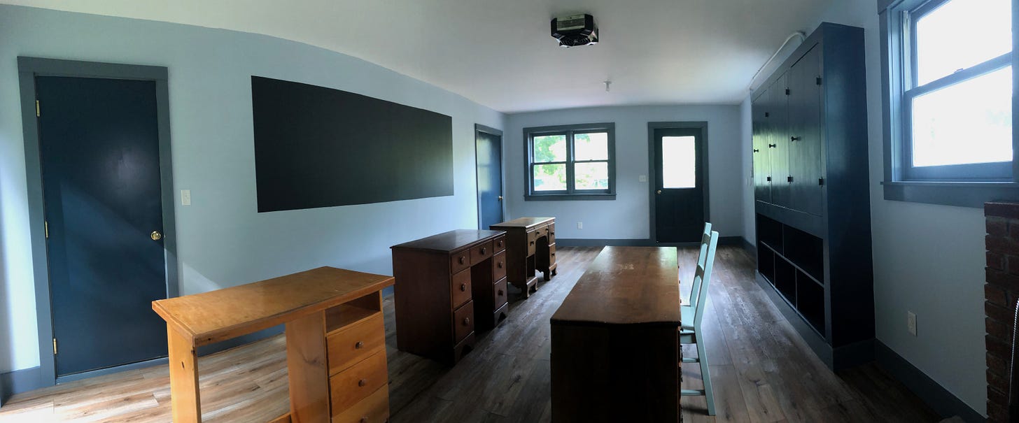 one-room schoolhouse with empty desks