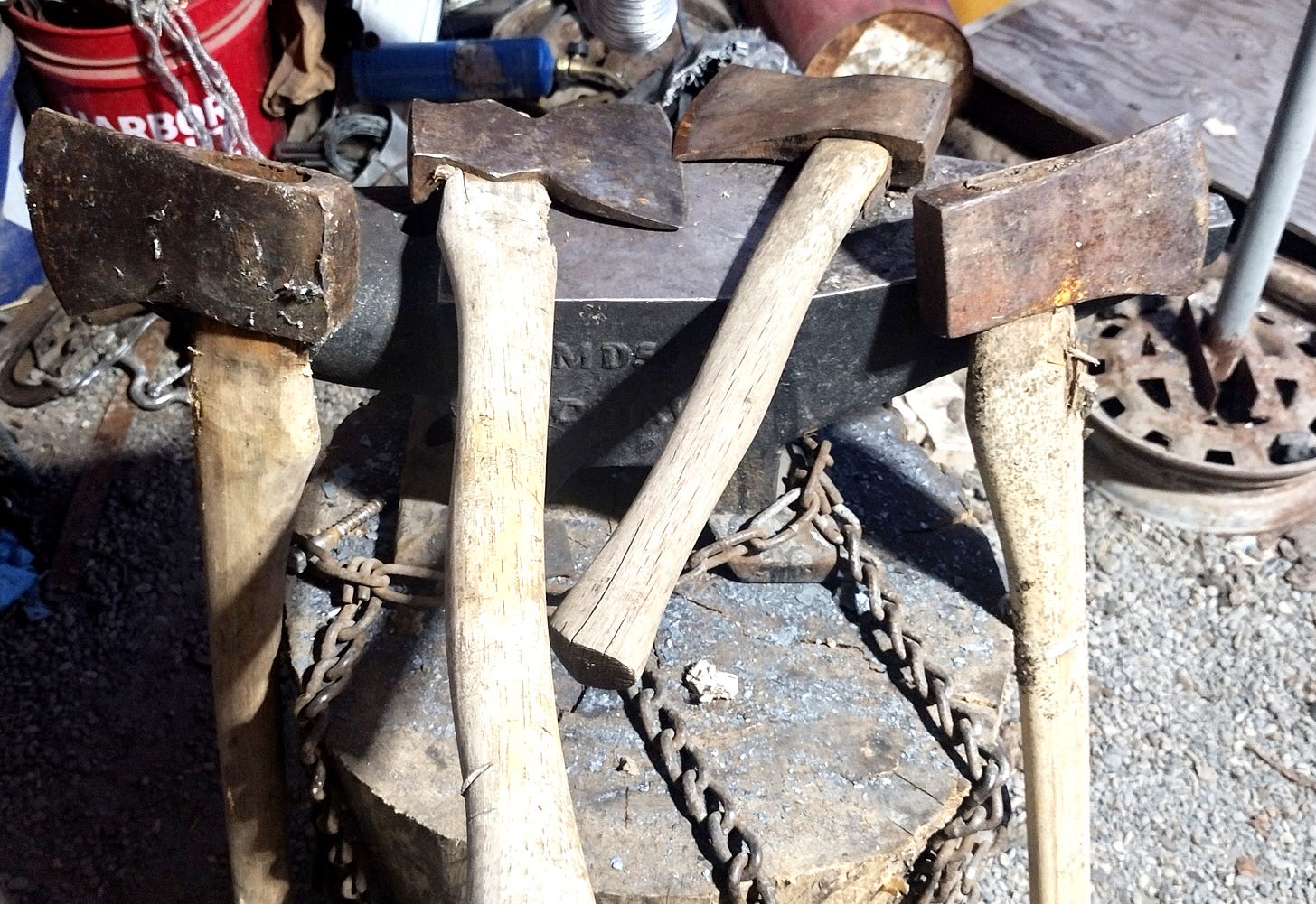 Four axes on an anvil