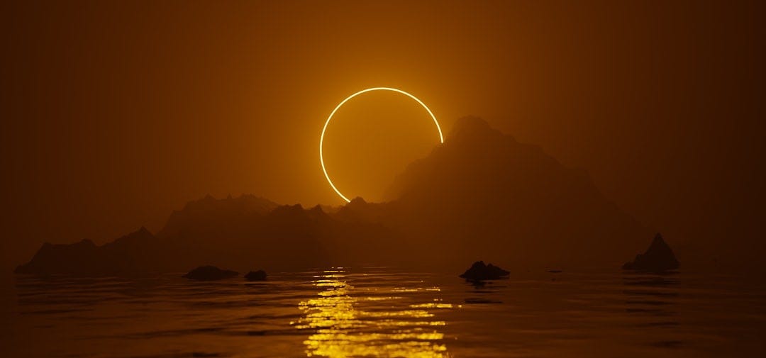 the sun is setting over a body of water