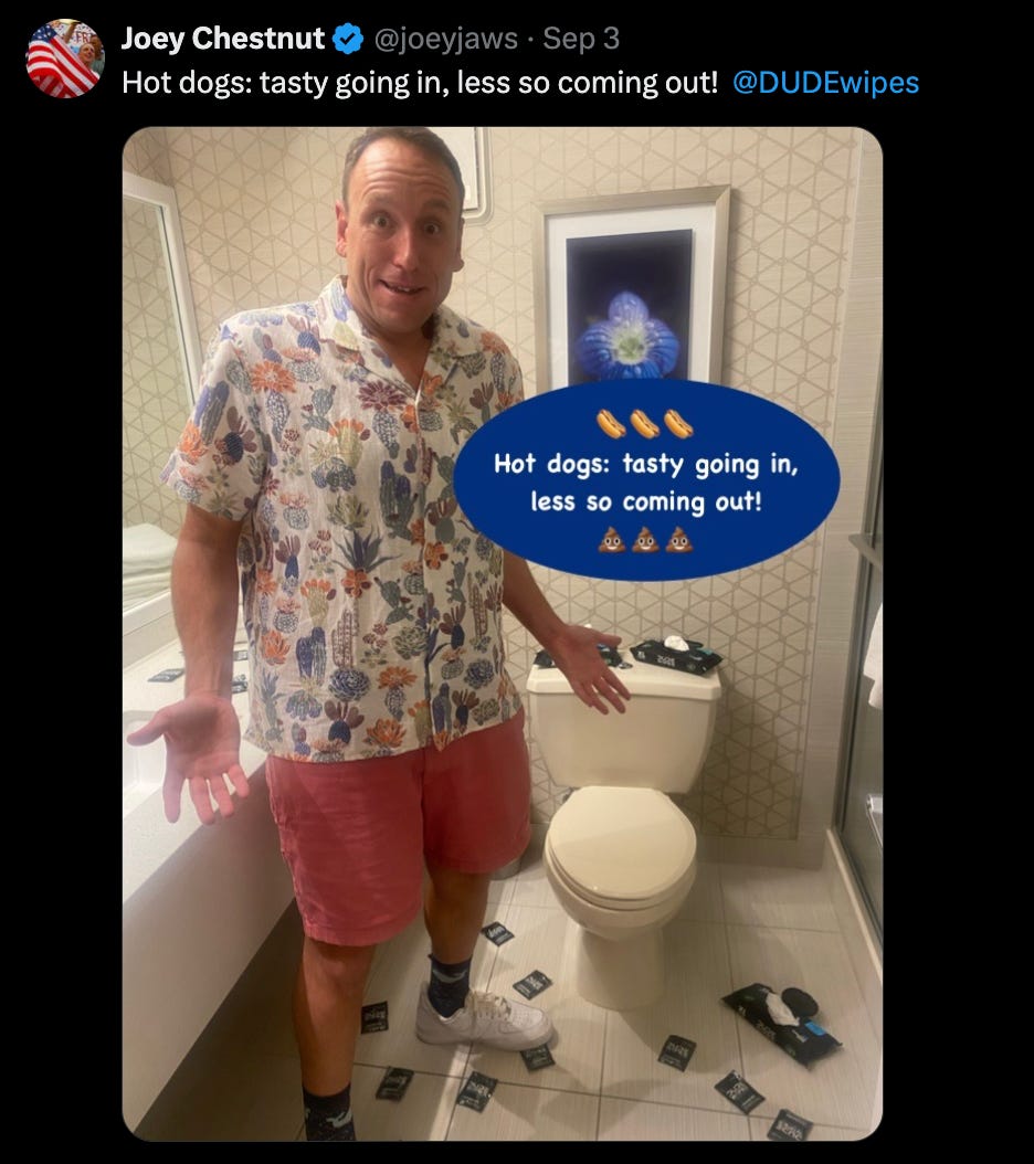 A tweet from @joeyjaws that says "Hot dogs: tasty going in, less so coming out" and features a picture of Joey Chestnut in a hotel bathroom (clothed) with a (closed) toilet and dude wipes packs on the floor