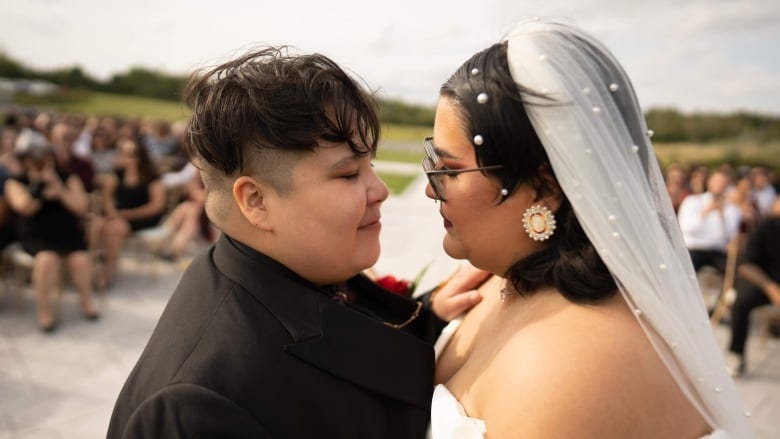 Indigenous couple hugging after they say their wedding vows.