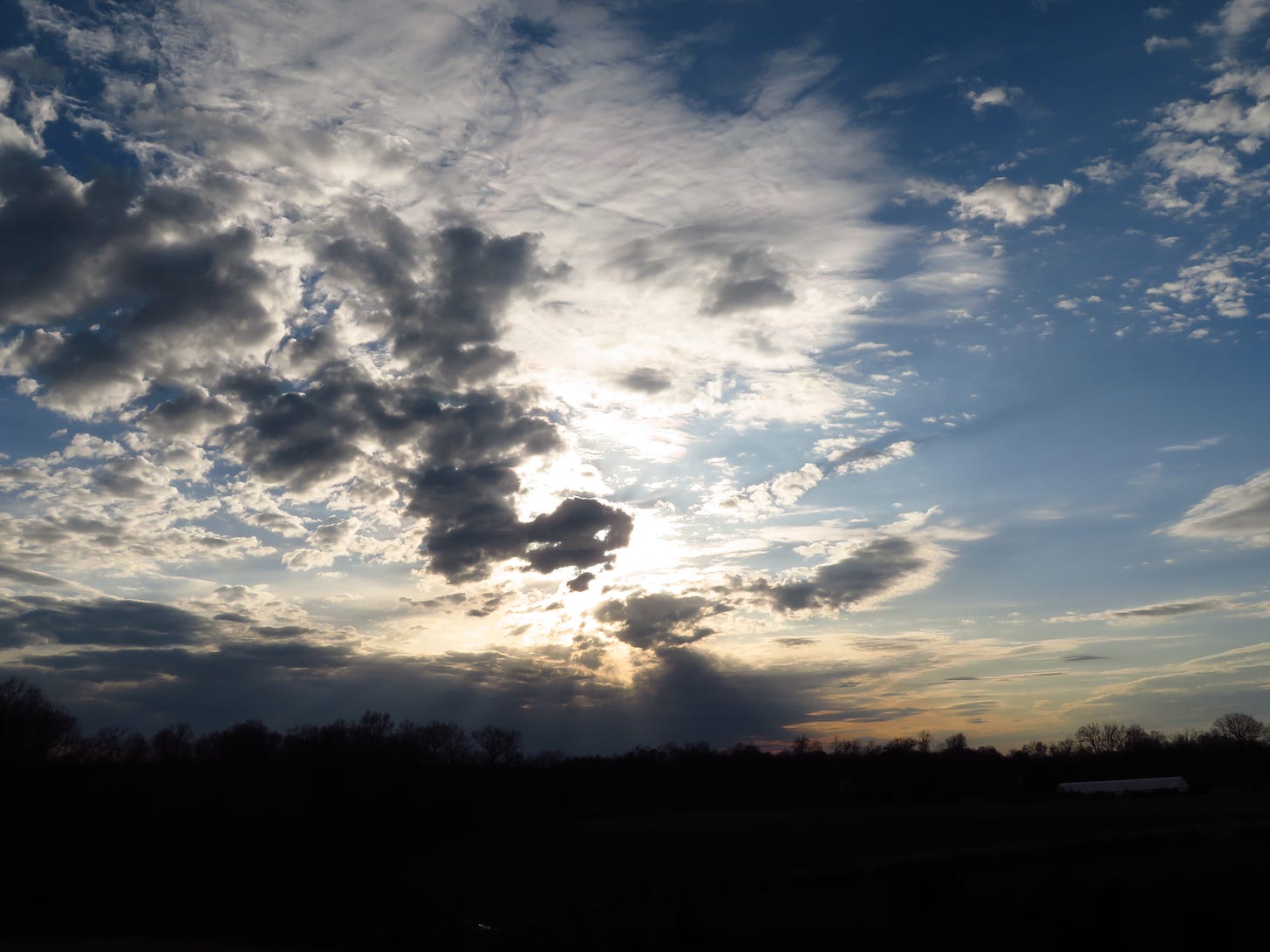 sun shining through a cloudy sky