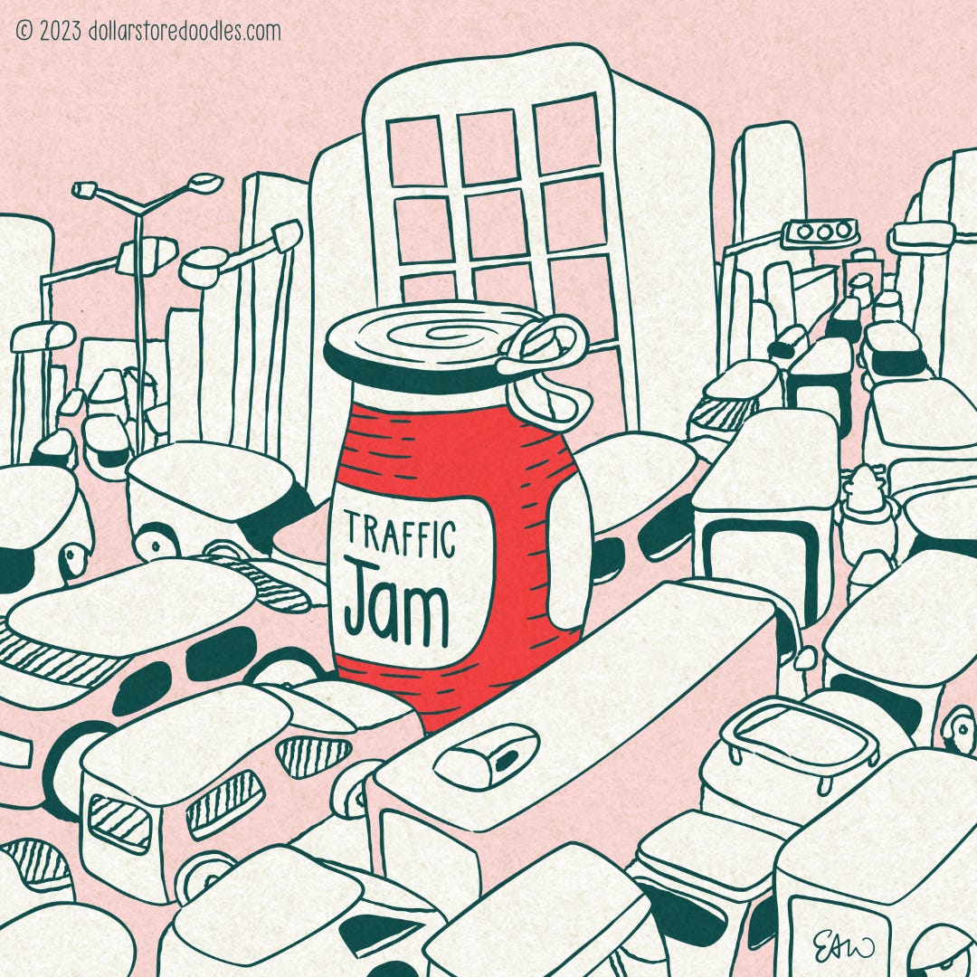 Cartoon drawing in teal and red tones showing a chaotic and busy traffic jam scene at a downtown intersection. In the middle of the intersecting lines of cars and trucks is a large jar of jam. The label on the jar reads, "Traffic Jam."